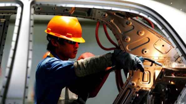 A Chinese worker on an assembly line at the Zhejiang Geely auto factory in Zhejiang province