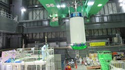 Workers operate a cask to remove nuclear fuel rods at No 4 reactor at Fukushima Workers operate a cask to remove nuclear fuel rods at No 4 reactor at Fukushima