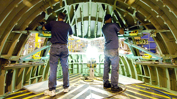 Boeing employees at work on a 777 cockpit