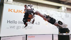 Hannover Messe attendees ride a roller coaster made from a Kuka industrial robot Hannover Messe attendees ride a roller coaster made from a Kuka industrial robot