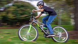 A boy rides a Kent International bicycle A boy rides a Kent International bicycle