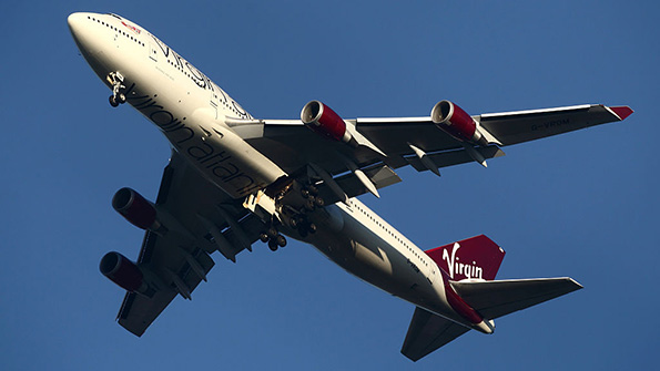A Virgin airplane soars through the sky