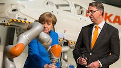 German Chancellor Angela Merkel tests a Kuka robot next to Kuka CEO Till Reuter German Chancellor Angela Merkel tests a Kuka robot next to Kuka CEO Till Reuter