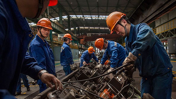 Production line workers at Zhong Tian Steel Group in Changzhou China