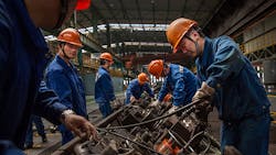Production line workers at Zhong Tian Steel Group in Changzhou China Production line workers at Zhong Tian Steel Group in Changzhou China