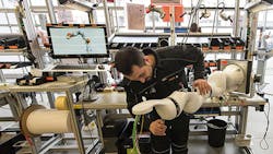 A worker builds a Kuka robotic arm at the companys factory in Augsburg Germany A worker builds a Kuka robotic arm at the companys factory in Augsburg Germany