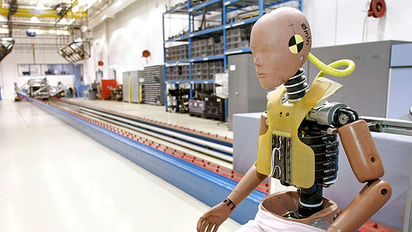 A crash test dummy sits in a Michigan testing facility
