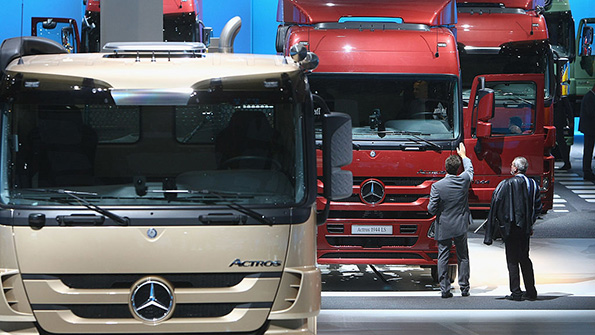 A row of Mercedes trucks at an industry event