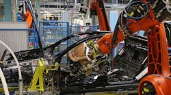 A Kuka robotic arm installs a dashboard on a Daimler AG Mercedes-Benz S-Class at the company&rsquo;s plant in Sindelfingen.