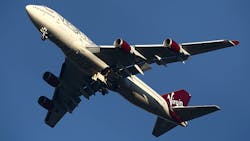 A Virgin plane soars through the sky A Virgin plane soars through the sky