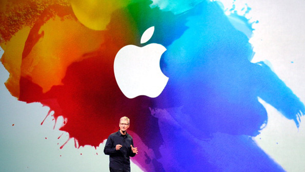 Apple CEO Tim Cook in front of the company logo