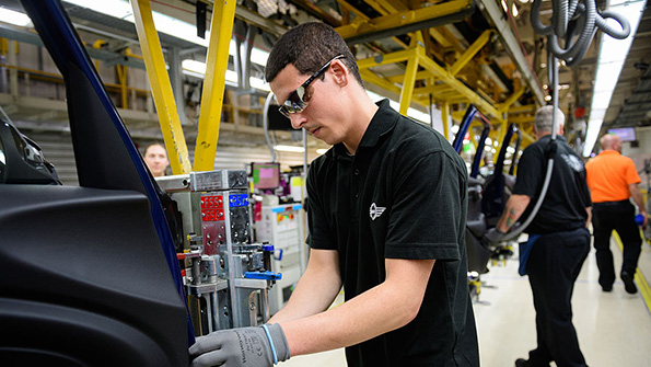 Workers assemble Mini automobiles at the companys Cowlet factory near Oxford