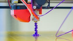 A 3D printer makes a vertical part A 3D printer makes a vertical part