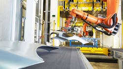 An industrial assemblyline robot works on auto panels An industrial assemblyline robot works on auto panels