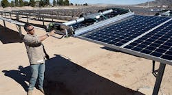 SunPower field supervisor Oscar Madrigal demonstrates a panel-washing robot on a row of solar panels at the 102-acre, 15-megawatt Solar Array II Generating Station at Nellis Air Force Base in Las Vegas.