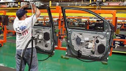 A worker assembles doors at a Ford plant A worker assembles doors at a Ford plant