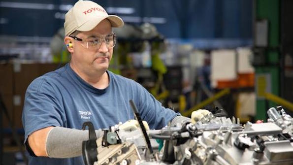 Team member Robert Sizemore readies a 6cylinder engine on the final assembly line Sizemore has worked at Toyota West Virginia for more than 16 years