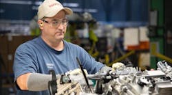 Team member Robert Sizemore readies a 6-cylinder engine on the final assembly line. Sizemore has worked at Toyota West Virginia for more than 16 years.