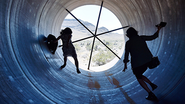 Two women walk through the Las Vegas tunnel built for a Hyperloop One event