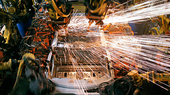 Robots working on the body of a car on the assembly line