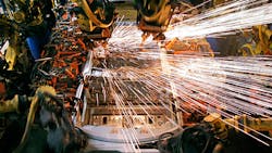 Robots working on the body of a car on the assembly line Robots working on the body of a car on the assembly line