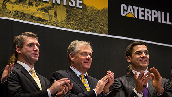 Caterpillar CEO Doug Oberhelman claps after ringing the NYSE opening bell