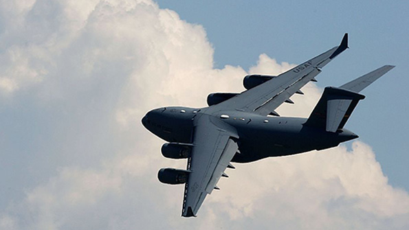 A Lockheed C17 Globemaster transport flies over an aircraft show