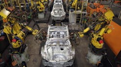 Robotic arms assemble and weld the body shell of a Nissan car on the production line at Nissan&apos;s Sunderland plant in England.