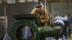 An employee works at Pioneer Pipe in Marietta Ohio An employee works at Pioneer Pipe in Marietta Ohio