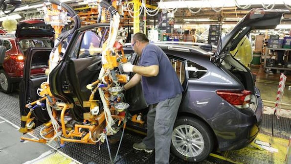 A worker puts the finishing touches on one of the first Imprezas produced at the Subaru plant in Lafayette Ind
