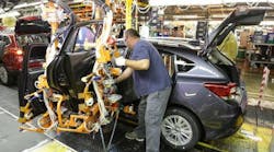 A worker puts the finishing touches on one of the first Imprezas produced at the Subaru plant in Lafayette, Ind.