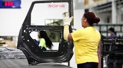 A worker handles a door at the Fiat Chrysler Warren (Mich.) Stamping Plant earlier this year.