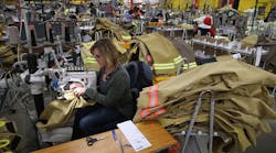 Employees of Globe Manufacturing in New Hampshire assemble firefighting clothing and gear.
