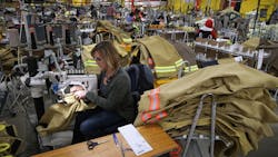 Employees of Globe Manufacturing in New Hampshire assemble firefighting clothing and gear Employees of Globe Manufacturing in New Hampshire assemble firefighting clothing and gear