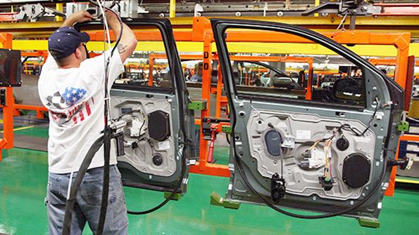 A worker assembles doors at a Ford plant in Illinois