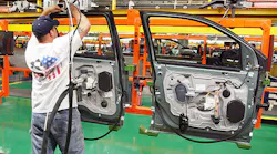 A worker assembles doors at a Ford plant in Illinois