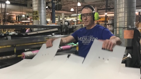 MDI employee Randy Carlson assembles postal bins