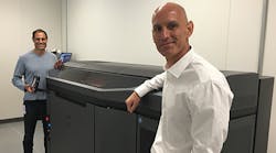 Jabil Circuit COO Bill Muir, right, and John Dulchinos, VP, Global Automation and 3-D Printing, show off the first installation of the HP Jet Fusion Printer, which 3-D prints 10 times faster than any other current machines.
