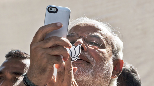 Indian Prime Minister Narendra Modi snaps a photo on his iPhone