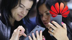 Two show attendees test the Huawei Honor 7 at the 2015 IFA Two show attendees test the Huawei Honor 7 at the 2015 IFA