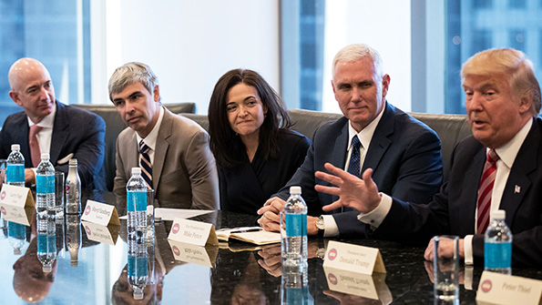 Amazon CEO Jeff Bezos listens to Presidentelect Donald Trump