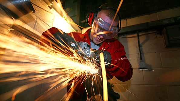 A grinding machine shop apprentice