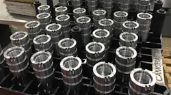 Fuel injector bodies lined up at the plant of Illinois automotive component supplier Camcraft