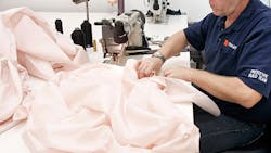 A Takata prototype build team member sews an airbag A Takata prototype build team member sews an airbag