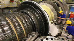 Workers assemble a gas turbine at a Siemens factory in Berlin