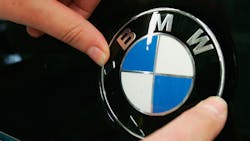 The BMW logo on a car hood The BMW logo on a car hood