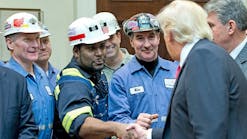 President Donald Trump with coal miners in February, after striking down Obama-era surface water protection regulations.