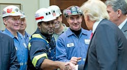 President Donald Trump with coal miners in February, after striking down Obama-era surface water protection regulations.