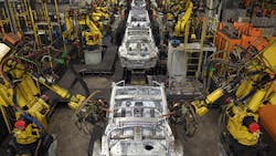 Industrial robots work on cars at a Nissan plant Industrial robots work on cars at a Nissan plant