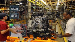 Workers assemble equipment while referencing a headsup display HUD Workers assemble equipment while referencing a headsup display HUD